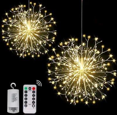 Two starburst-shaped LED lights hang against a black background, with a battery pack and remote control shown in the lower left corner.