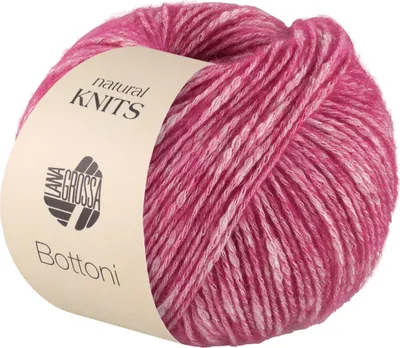 A ball of pink and white variegated yarn with a label.