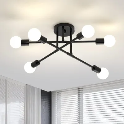 A black, multi-arm ceiling light fixture with six exposed white light bulbs is mounted on a white ceiling.
