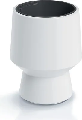 A white planter with a black interior sits on a white surface with a subtle shadow.