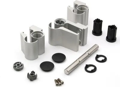 A collection of metal and plastic hardware components, likely for a door or window system, laid out on a white background.