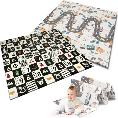 A baby crawling on a play mat with other folded play mats in the background.