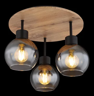 A ceiling light fixture with three glass globes and a wooden base.