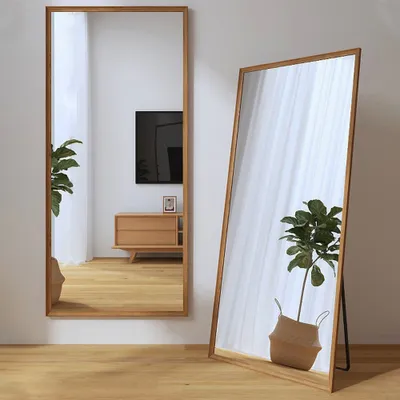 Two full-length mirrors with wooden frames are shown in a room with wooden floors and white curtains.