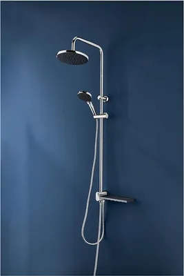 A shower set mounted on a blue wall.