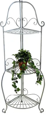 A silver metal corner shelf unit with a potted plant on one of the shelves.