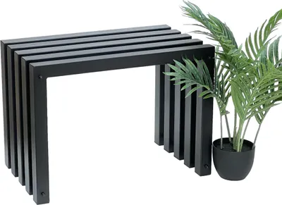 A black metal bench with a slatted top and vertical supports, placed next to a potted green plant.