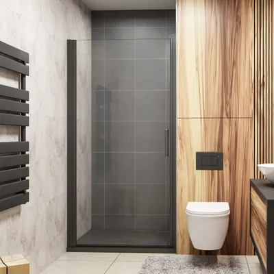 A modern bathroom with a shower enclosure, toilet, and wooden wall paneling.
