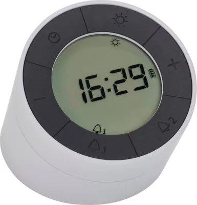 A digital alarm clock with a round display and buttons around the edge.