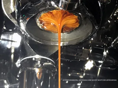Close-up shot of espresso being extracted from an espresso machine.