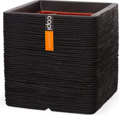 A black square planter with a textured surface and an orange and white label.