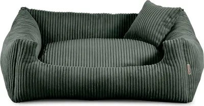 A green dog bed with a small pillow.