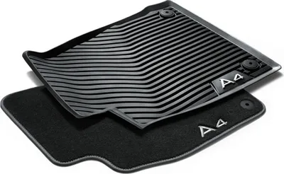 A set of car floor mats, one rubber and one carpet, are shown against a white background.
