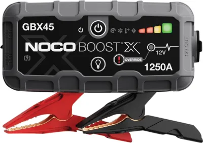 A car jump starter and its attached jumper cables are shown against a white background.