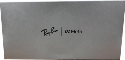 The image shows the Ray-Ban and Meta logos on a gray textured surface, likely packaging.