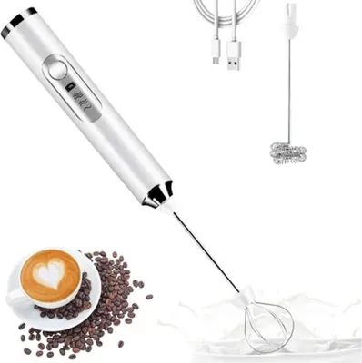 A white electric milk frother with its attachments and accessories, including coffee beans and a cup of coffee.
