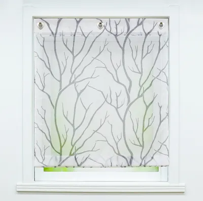 A white window frame with a white sheer curtain featuring a gray tree branch pattern.