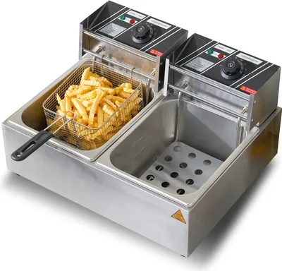 A commercial electric deep fryer with two baskets, one filled with french fries, shown on a white background.