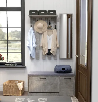 An entryway with a coat rack, bench, and mirror.