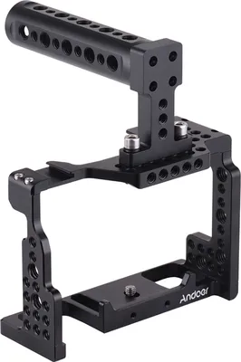 A black camera cage with a top handle, shown from a three-quarter angle against a white background.