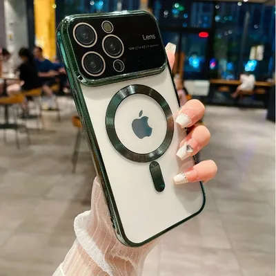 A person is holding a green iPhone case with a MagSafe ring and Apple logo on it. The background is blurred and shows a restaurant or cafe setting.