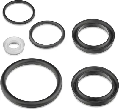 A collection of rubber and plastic seals on a white background.