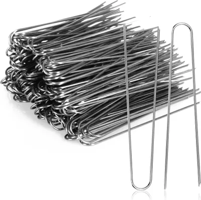 A pile of U-shaped metal pins, with two pins in the foreground for detail.
