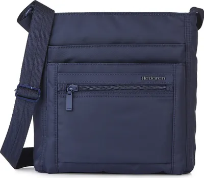 A close-up studio shot of a blue Hedgren crossbody bag.
