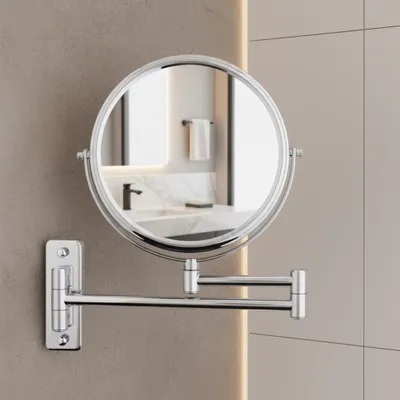 A wall-mounted makeup mirror in a bathroom.