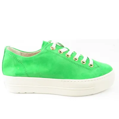 A side view of a green sneaker with a white sole and white laces, set against a white background.