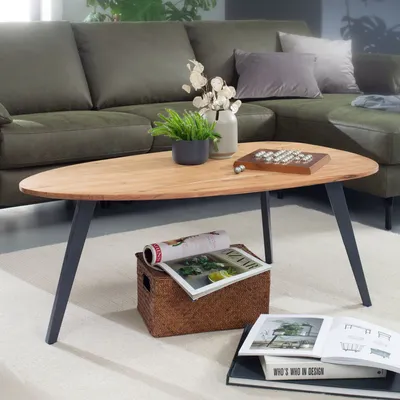 A living room scene with a green sectional sofa and a wooden coffee table.