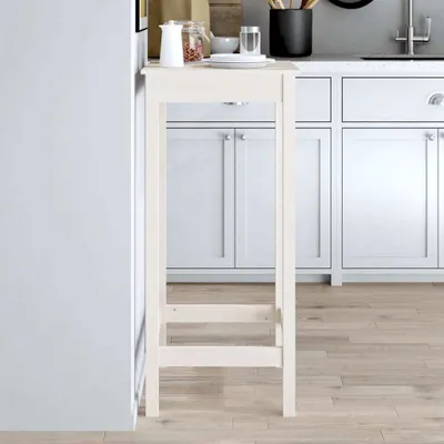 A white bar cart is placed in a kitchen next to white cabinets and a light wood floor.