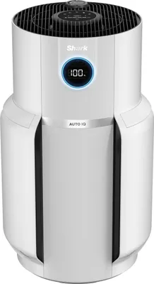 A white air purifier with a digital display and a black top grill, shown from a front-diagonal angle.