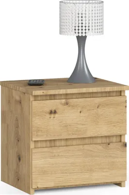 A wooden nightstand with two drawers and a lamp on top.