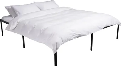 A white duvet and pillows are neatly arranged on a black metal bed frame against a white background.