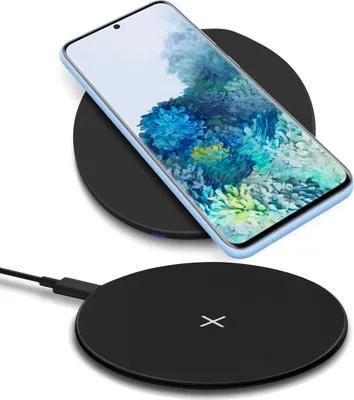A smartphone is shown charging on a wireless charging pad, with another charging pad visible below it.