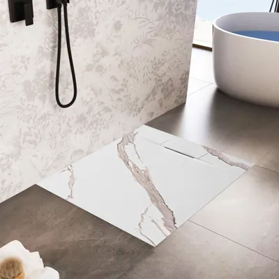 A modern bathroom with a shower tray, bathtub, and patterned wallpaper.