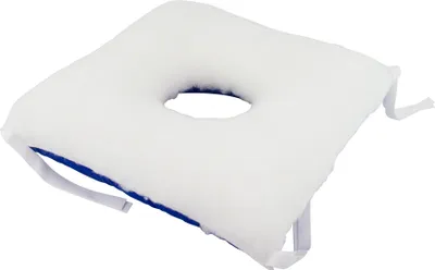A white cushion with a hole in the center and blue trim, shown on a white background.