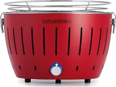 A red LotusGrill charcoal grill is shown from the front on a white background.