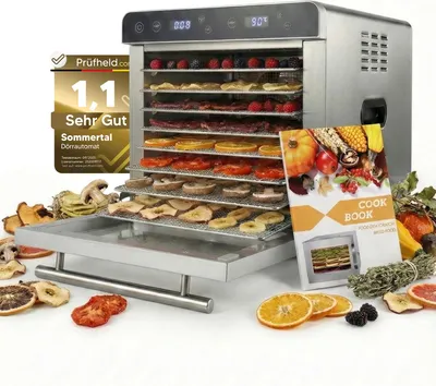 A food dehydrator with various dried fruits and vegetables displayed around it, along with a cookbook.