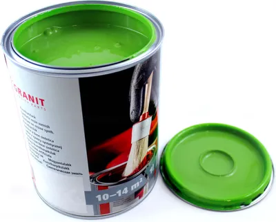 A can of green paint with its lid off, placed on a white background.