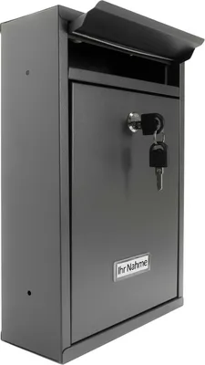 A gray metal mailbox with a key in the lock and a nameplate.