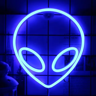 A blue neon alien head sign is displayed against a grid-like background with some faint images of buildings and text.