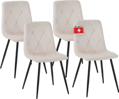 Four beige dining chairs with diamond-stitched upholstery and black metal legs are arranged in a group against a white background.