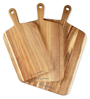 Three wooden cutting boards are arranged in a layered fashion against a white background.
