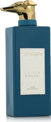 A product shot of a blue perfume bottle with a gold cap.