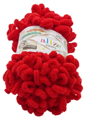 A ball of red fluffy yarn with a label.