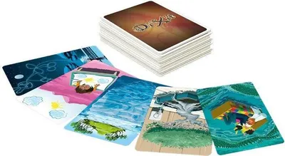 A stack of Dixit cards and several cards spread out in front of it.