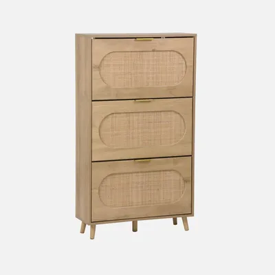 A wooden shoe cabinet with three flip-down doors, each featuring a rattan-style insert and a gold handle, set against a light gray background.