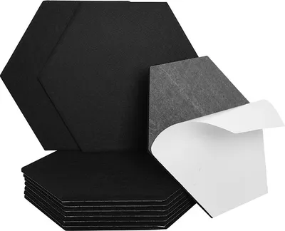 A stack of black hexagonal acoustic panels, with one panel partially peeled to reveal its adhesive backing.